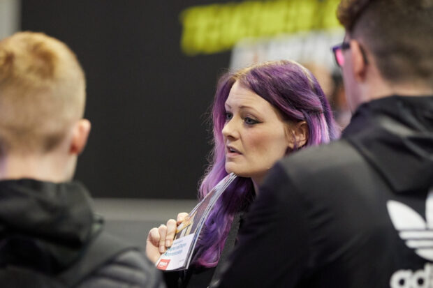A photo of a government official working with young people.